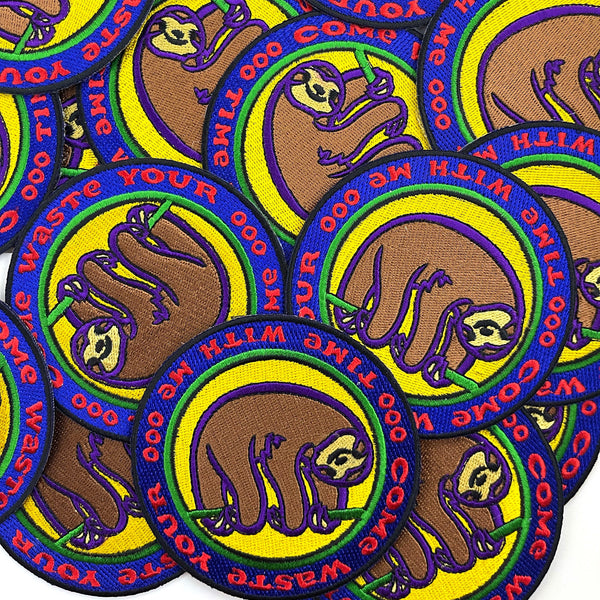 Collection of patches with a sloth design and text on a white background